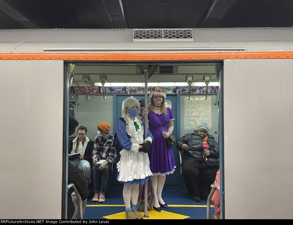 People showing their fancy outfits while standing inside the 1575 Subway Car at 2nd Ave Station